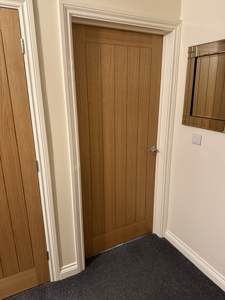 Internal oak door, freshly installed and latching cleanly